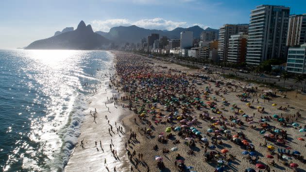 Beachgoers crowd Ipanema beach in Brazil. The country remains on the 