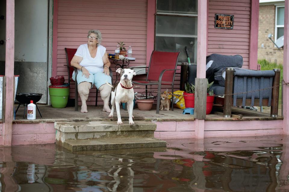 Concerns about health and home security are two reasons older adults might fear evacuating during disasters like Hurricane Harvey in 2017. <a href="https://www.gettyimages.com/detail/news-photo/rena-brannon-sits-on-the-porch-of-her-home-which-surrounded-news-photo/841968094" rel="nofollow noopener" target="_blank" data-ylk="slk:Scott Olson/Getty Images;elm:context_link;itc:0;sec:content-canvas" class="link ">Scott Olson/Getty Images</a>