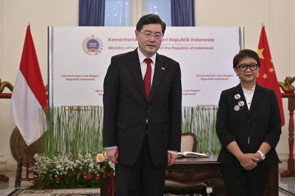 Indonesian Foreign Minister Retno Marsudi, right, and her Chinese counterpart Qin Gang pose for photographers during their meeting in Jakarta, Indonesia, Wednesday, Feb. 22, 2023. (Adek Berry/Pool Photo via AP)