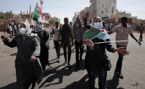 People chant slogans during a demonstration against the killing of dozens by Sudanese security forces since a military coup three months ago, in Khartoum, Sudan, Monday, Jan. 24, 2022. (AP Photo/Marwan Ali)