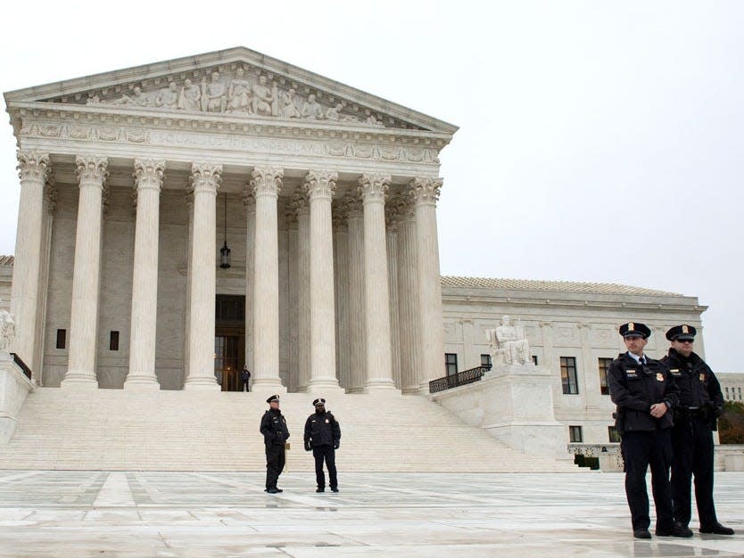 Police officers stand outside the Supreme Court in Washington, DC, on November 12, 2019. (Photo by Caroline Brehman_CQ Roll Call, Inc via Getty Images)