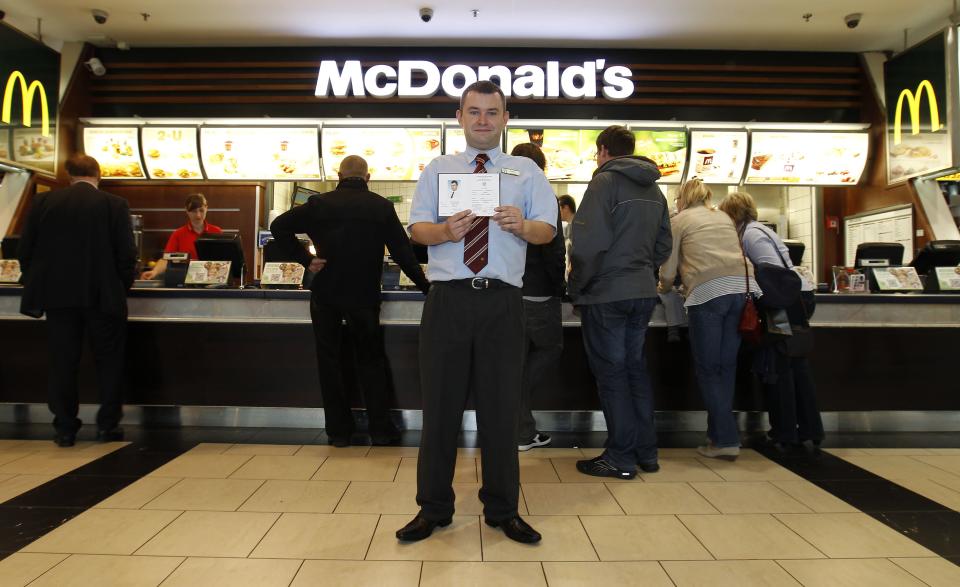 <h2>Managing a McDonald's in Warsaw</h2>Marcin Lubowicki, a 28 year-old deputy manager of a McDonald's restaurant, poses with his university diploma in front of the fast food chain in the Arkadia shopping mall, Warsaw May 16, 2012. Lubowicki, who has degree in Russian language from Warsaw University, has been working for McDonald's since 2007. He is planning to stay in his job.