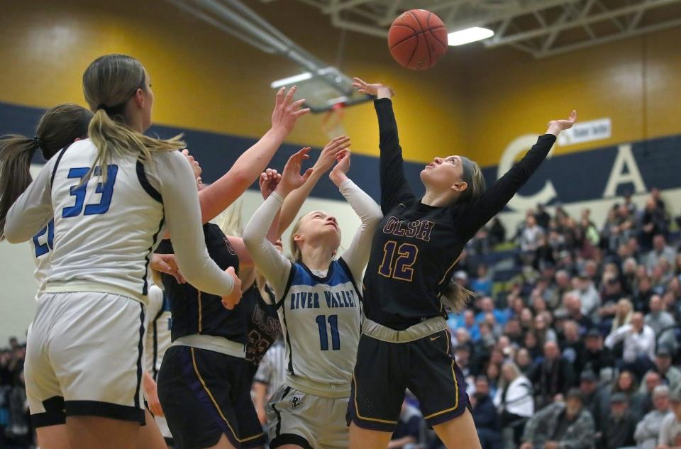 OLSH's Alyssa Minton (12) knocks the ball away from River Valley's Emilee Staats (11) while attempting to gain control of a rebound during the second half of the PIAA 3A Semifinals game Monday night at Kiski Area High School in Leechburg, PA.