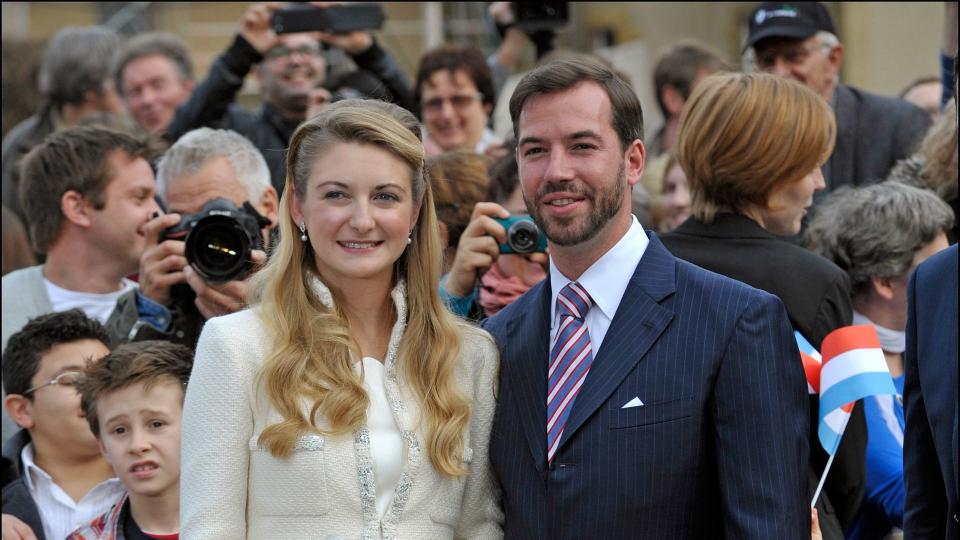 Countess Stephanie in a skirt suit with husband