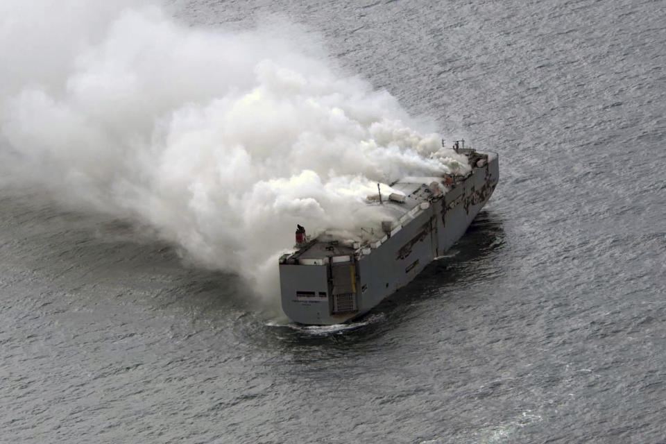 Smoke is seen from a freight ship in the North Sea, about 27 kilometers (17 miles) north of the Dutch island of Ameland, Wednesday, July 26, 2023. A fire on the freight ship Fremantle Highway, carrying nearly 3,000 cars, was burning out of control Wednesday in the North Sea, and the Dutch coast guard said it was working to save the vessel from sinking close to an important habitat for migratory birds. (Kustwacht Nederland/Coast Guard Netherlands via AP)