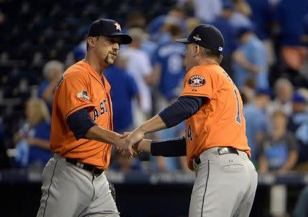 Oct 8, 2015; Kansas City, MO, USA; Houston Astros relief pitcher Luke Gregerson (left) celebrates with manager A.J. Hinch (14) after defeating the Kansas City Royals in game one of the ALDS at Kauffman Stadium. John Rieger-USA TODAY Sports