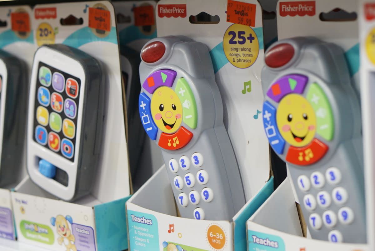 Closeup of a row of Fisher-Price toy phones on the shelf at a toy store