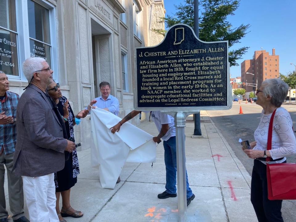 South Bend Mayor James Mueller, center, helps unveil a historical marker for husband-wife attorneys and civil rights figures J. Chester and Elizabeth Allen on Saturday, Sept. 18, while historian Gabrielle Robinson, right, and Allen family members look on.
