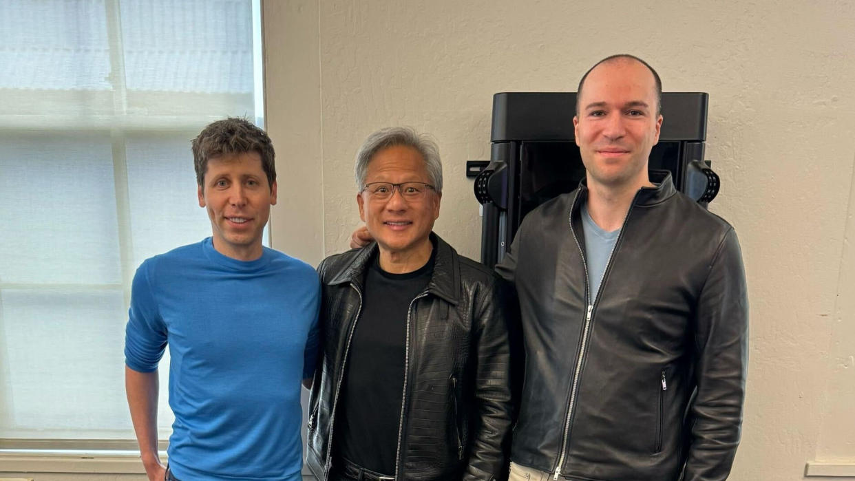  A photo from the Twitter account of Greg Brockman, showing Sam Altman, Jensen Huang and Greg Brockman standing in front of the first of Nvidia's DGX H200 AI GPUs. . 