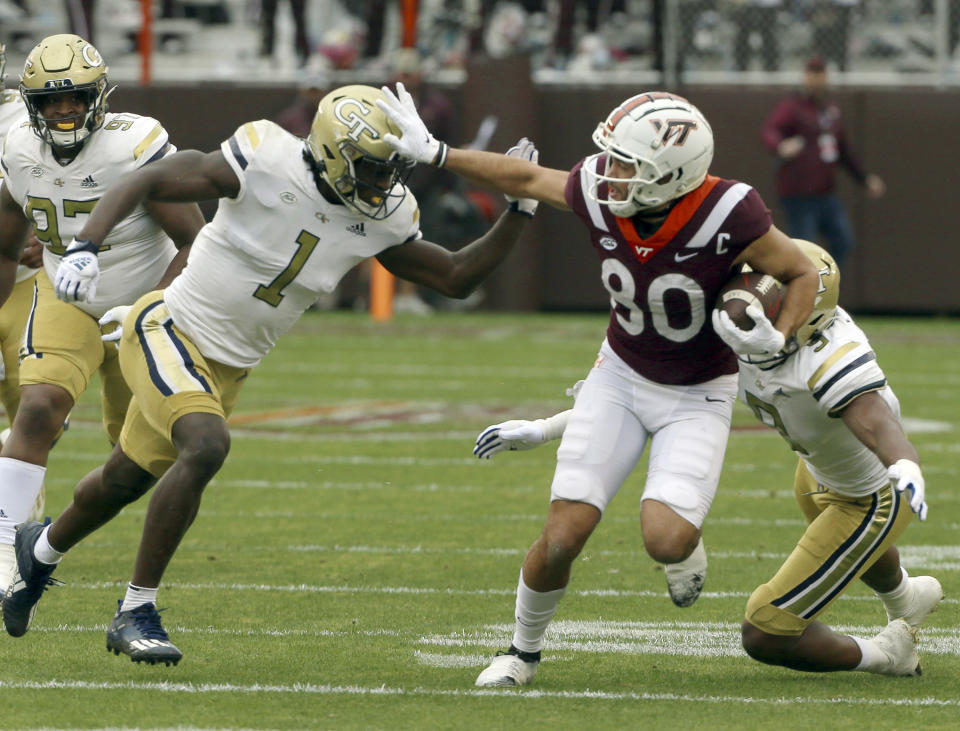 Virginia Tech's Kaleb Smith (80) runs the ball past Georgia Tech's Charlie Thomas (1) and Kyle Kennard (9) in the first half during an NCAA college football game, Saturday, Nov. 5 2022, in Blacksburg, Va. (Matt Gentry/The Roanoke Times via AP)