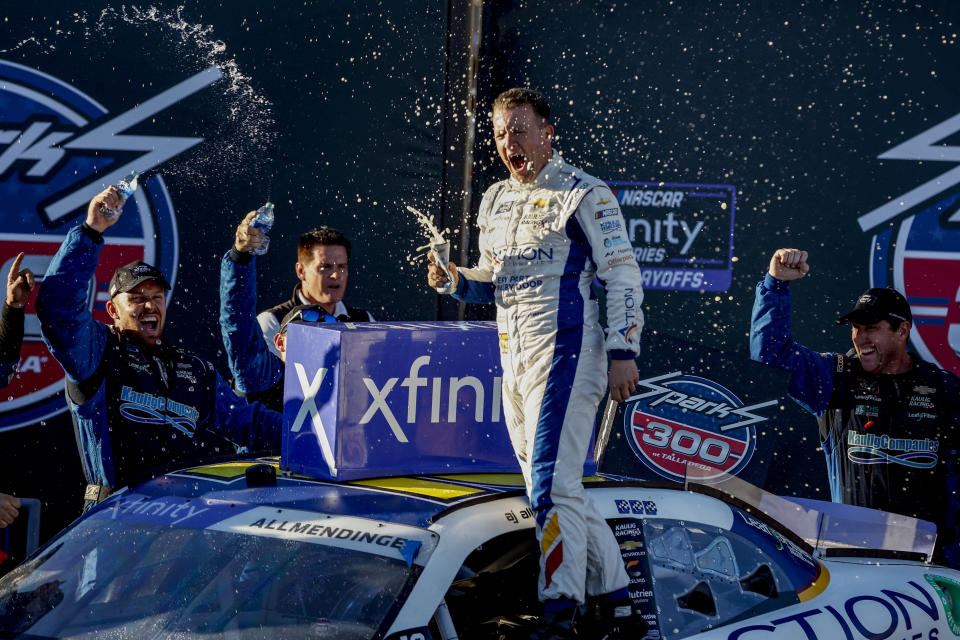 AJ Allmendinger celebrates in Victory Lane after winning the NASCAR Xfinity Series auto race Saturday, Oct. 1, 2022, in Talladega, Ala. (AP Photo/Butch Dill)