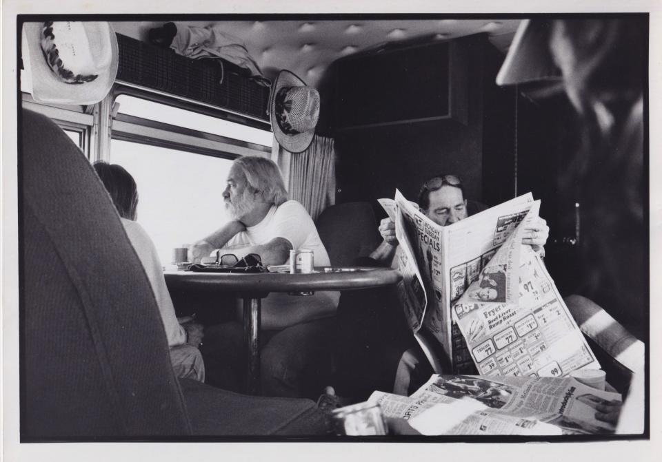 Willie Nelson reads the newspaper on the tour bus. (Michael Abramson/Courtesy of HarperCollins Publishers)