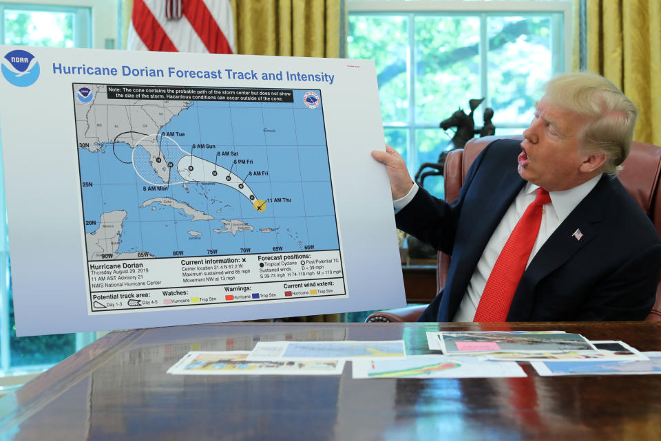 In the Oval Office of the White House, President Donald Trump holds a chart showing the original projected track of Hurricane Dorian that appears to have been extended with a black line to include parts of the Florida panhandle and Alabama on Sept. 4, 2019.  (Photo: Jonathan Ernst / Reuters)