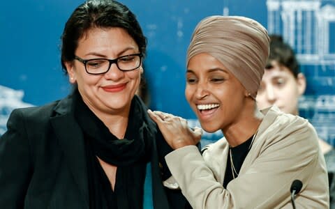 Rashida Tlaib (L) and Ilhan Omar (R) react as they discuss Israel's decision to block their visit - Credit: Reuters