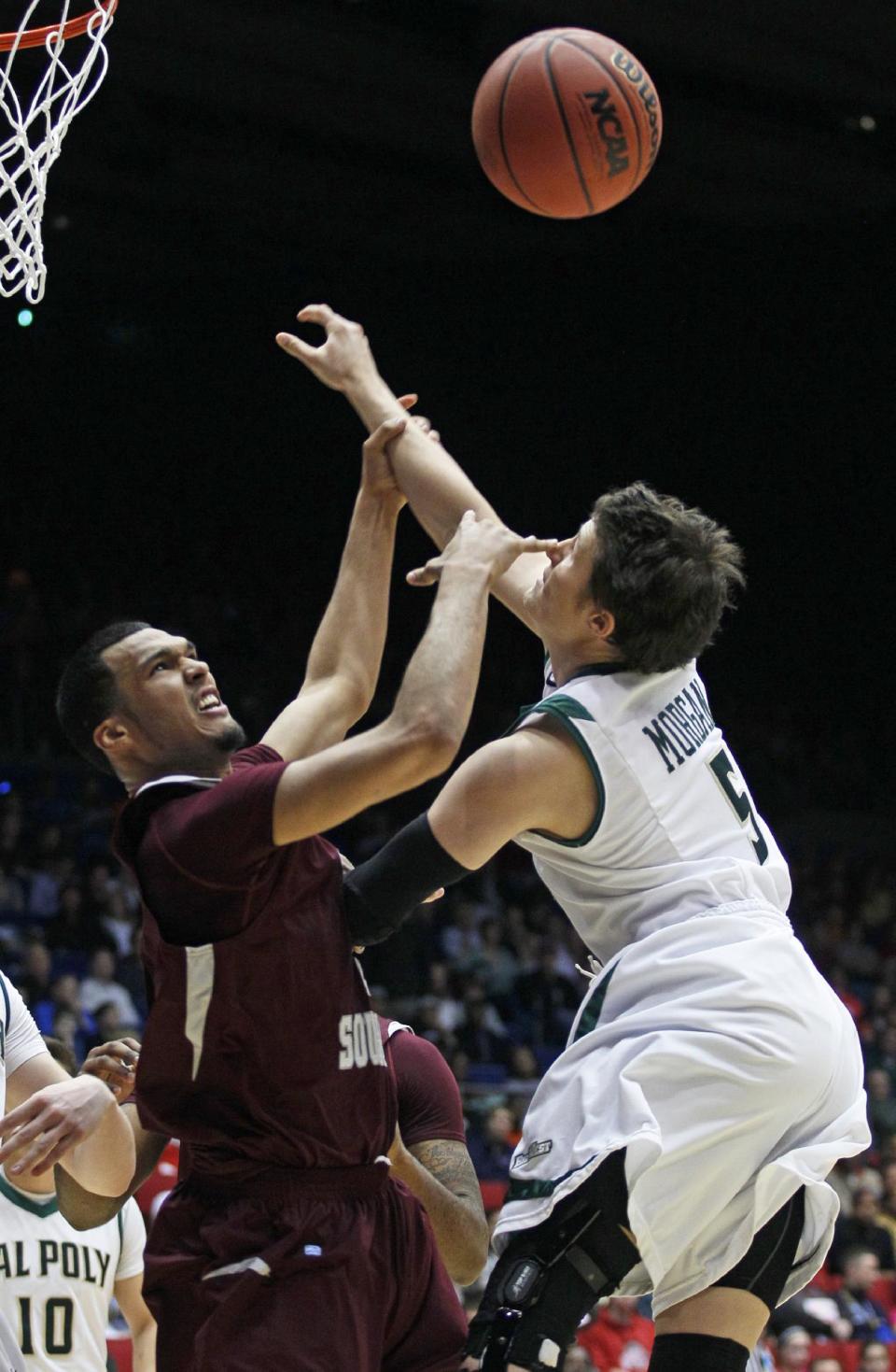 Texas Southern forward Jose Rodriguez, left, and Cal Poly guard Reese Morgan (5) rebound in the first half of a first-round game of the NCAA college basketball tournament on Wednesday, March 19, 2014, in Dayton, Ohio. (AP Photo/Skip Peterson)