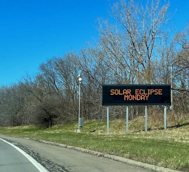 An electric sign along New York State Route 390, south of Crescent Beach along Lake Ontario, advises motorists about expected delays for the April 8, 2024, solar eclipse.