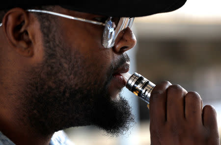 A customer at House of Vapes, uses a vape in London, Britain August 17, 2018. REUTERS/Peter Nicholls