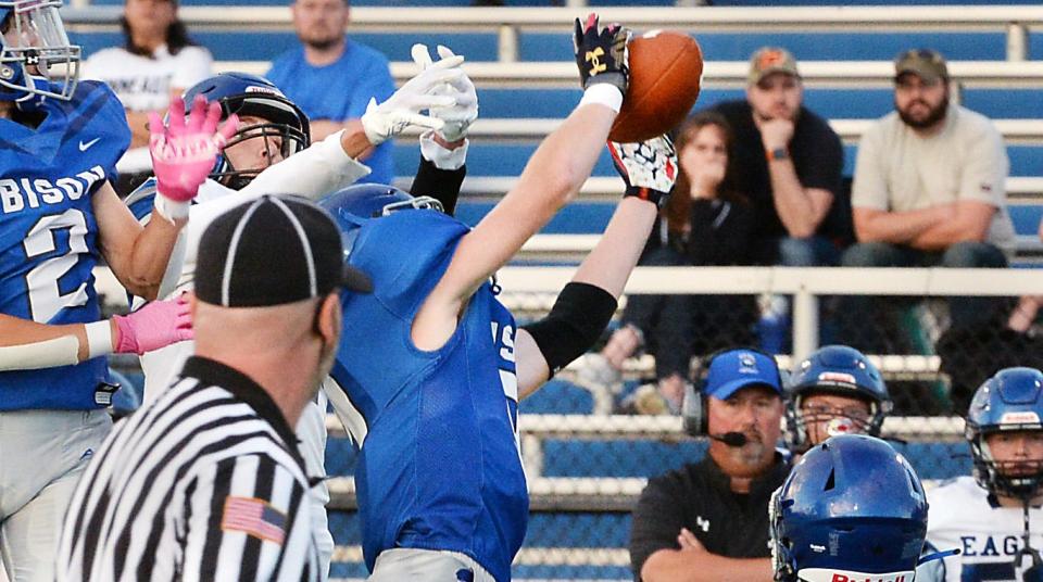 Fort LeBoeuf'S Damian Blose, center, intercepts a pass against Conneaut, which he returned for a touchdown, at Carm Bonito Field in Waterford on Aug. 26, 2022.