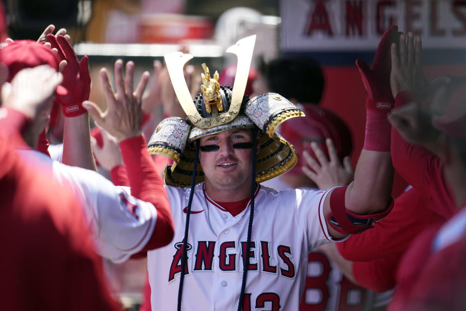 Los Angeles Angels' Hunter Renfroe (12) celebrates his two-run home run with teammates in the dugout during the first inning of a baseball game against the Toronto Blue Jays Sunday, April 9, 2023, in Anaheim, Calif. (AP Photo/Marcio Jose Sanchez)