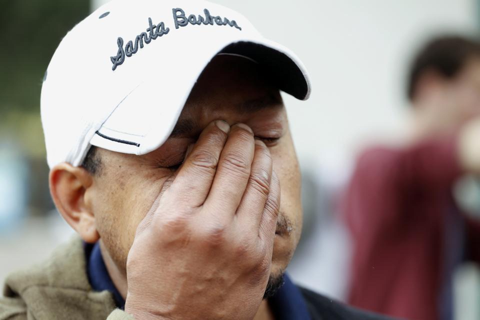 UCSB student Derrick Hayes wipes away tears outside a deli that was one of nine crime scenes after series of drive -by shootings that left 7 people dead in the Isla Vista section of Santa Barbara