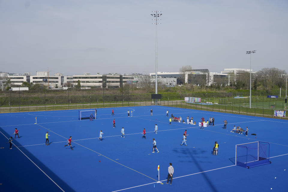 Youths play field hockey, at the renovated Yves-du-Manoir stadium in Colombes, outside Paris, Thursday, March 21, 2024. The stadium will host the men's and women's field hockey competitions during the Pairs 2024 Olympic Games (AP Photo/Thibault Camus)