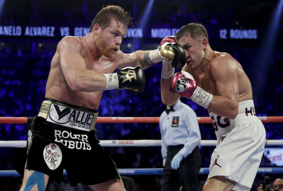 Canelo Alvarez, left, and Gennady Golovkin trade punches in the sixth round during a middleweight title boxing match, Saturday, Sept. 15, 2018, in Las Vegas. (AP Photo/Isaac Brekken)