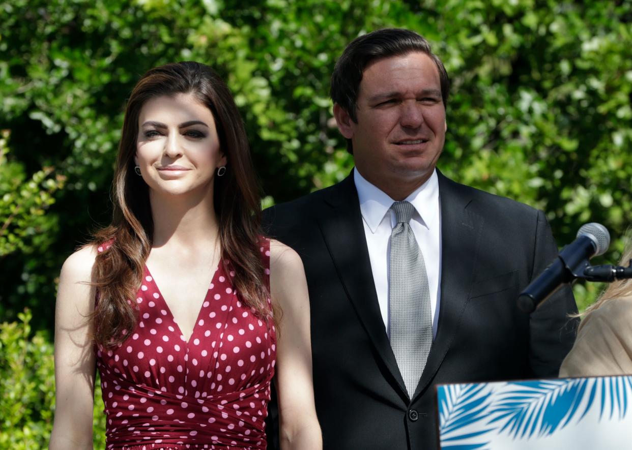 Florida Gov. Ron DeSantis, right, stands with his wife Casey during a news conference where the Miami Super Bowl Host Committee announced the launch of Ocean to Everglades (O2E), a Super Bowl LIV environmental initiative, at the Marjory Stoneman Douglas Biscayne Nature Center, Monday, April 22, 2019, in Key Biscayne, Florida.
