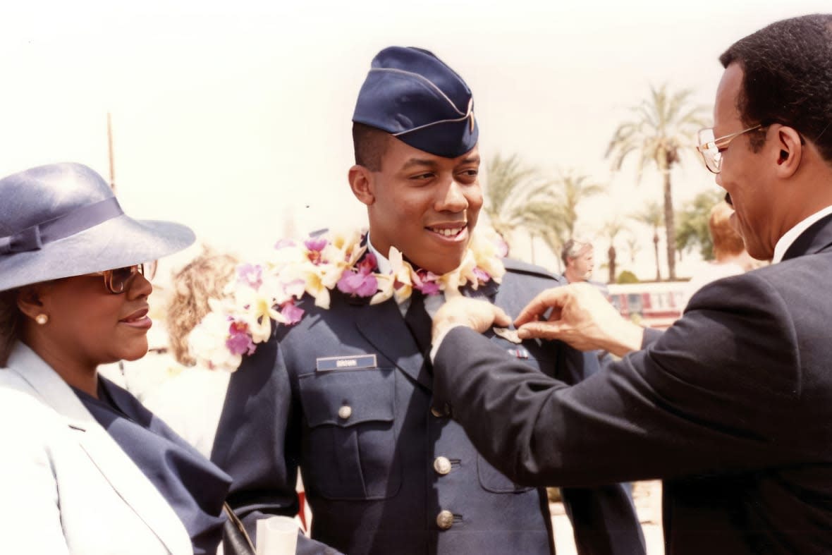 In this photo provided by the Brown family, retired Army Col. Charles Q. Brown, Sr., father, and his wife Kay Brown, pin Air Force wings onto the uniform of their son, 2nd Lt. CQ Brown, Jr., at his pilot training graduation at Williams Air Force Base, Ariz., in 1986. (Brown family via AP)