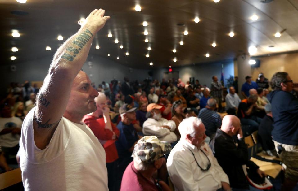 Veteran Mark Howey waits to ask a question as Sen. John McCain speaks during a forum with veterans on Friday, May 9, 2014, in Phoenix. McCain was discussing lapses in care at the Phoenix Veterans Affairs hospital that prompted a national review of operations around the country. (AP Photo/Matt York)