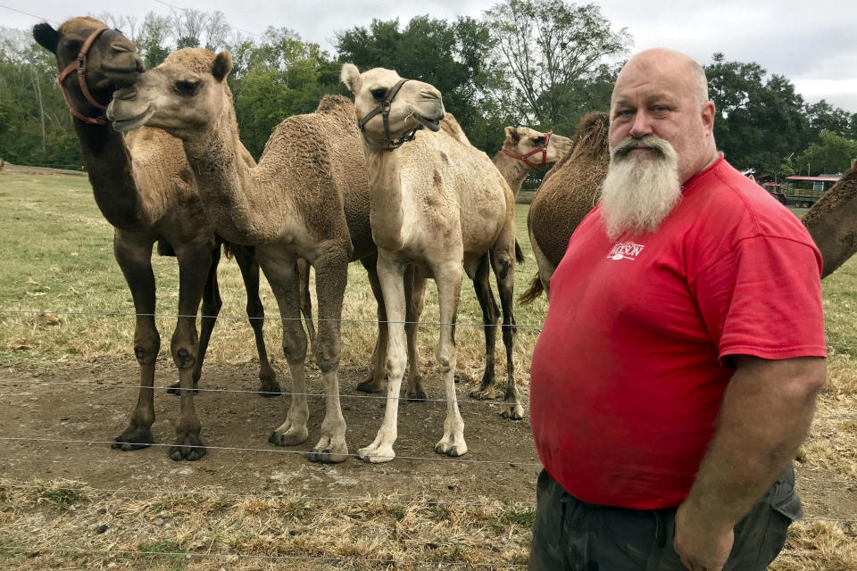 In this Oct. 7, 2019 photo, Scott Allen, who runs Pettit Creek Farms in bone-dry Bartow County, Ga., poses for a photo. Allen says the small streams normally used to provide water for his camels, kangaroos, zebras and other animals have dried up so they are forced to rely on other water sources. Allen says the animals are fine, but the dust is relentless since there's been no significant rain during the past two months. (AP Photo/Jeff Martin) (AP Photo/Jeff Martin)