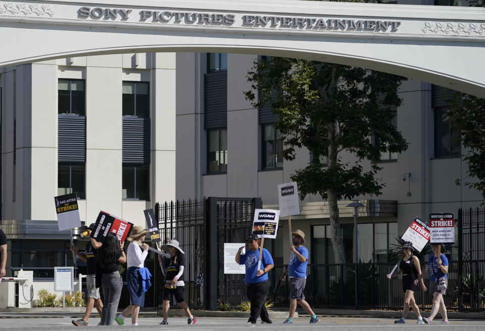 Striking writers and actors take part in a "Bastille Day: Let Them Eat Croissants" rally outside Sony Pictures studio in Culver City, Calif. on Friday, July 14, 2023. This marks the first day actors formally joined the picket lines, more than two months after screenwriters began striking in their bid to get better pay and working conditions. (AP Photo/Mark J. Terrill)