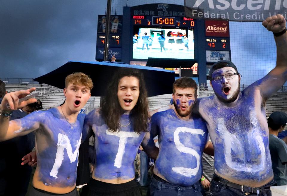 MTSU students left to right Cameron Eschenfelder, Edward Tran, Jerry Denton and Ethan Cela, cheer on their team during the first MTSU home football game at MTSU's Floyd Stadium against Murray State on Saturday, Sept. 16, 2023.