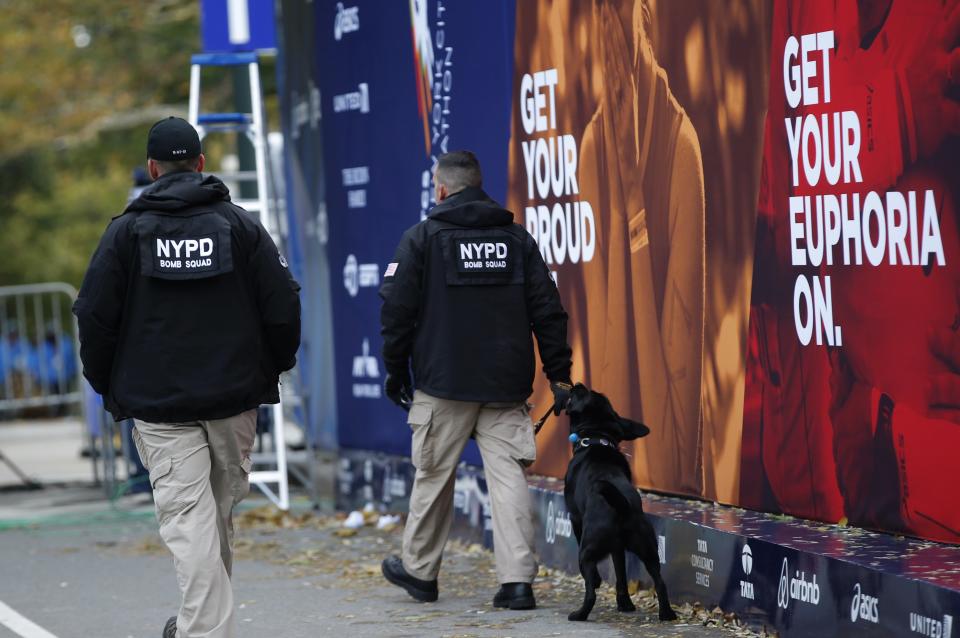New York Police department bomb squad officers patrol the area near the finish line ahead of the 2014 New York City Marathon in Central Park in Manhattan, November 2, 2014. REUTERS/Mike Segar (UNITED STATES - Tags: SPORT ATHLETICS ANIMALS)