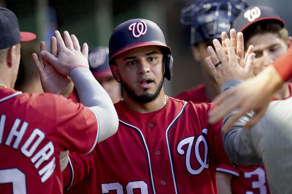 Washington Nationals' Keibert Ruiz celebrates in the dugout after scoring against the Pittsburgh Pirates during the fourth inning of a baseball game in Pittsburgh, Tuesday, Sept. 12, 2023. (AP Photo/Matt Freed)