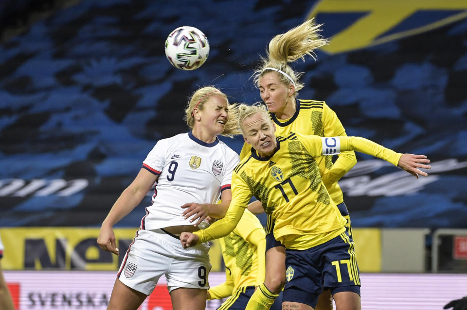 United States' Lindsey Horan, left, and Sweden's Caroline Seger (17) and Linda Sembrant battle for a head ball during the women's international friendly soccer match between Sweden and USA at Friends Arena in Stockholm, Sweden, Saturday, April 10, 2021. (Janerik Henriksson/TT via AP)