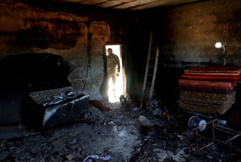 FILE PHOTO: A fighter loyal to Libya's U.N.-backed government (GNA) looks at a room burned during clashes with troops loyal to Khalifa Haftar in Wadi Rabiya neighbourhood at outskirts of Tripoli