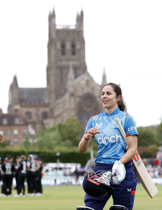 Maia Bouchier celebrates her match-winning century against New Zealand in the second one-day international at New Road with Worcester Cathedral in the background