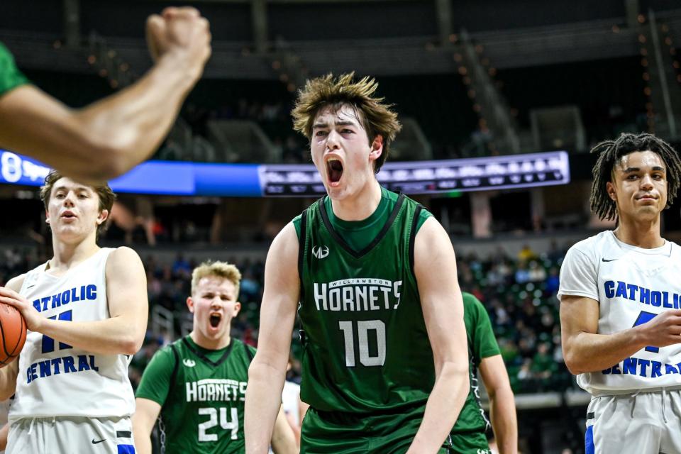 Williamston's Max Burton celebrates after Mason Docks made a basket and was fouled by Grand Rapids Catholic Central during the second quarter in the Division 2 state final on Saturday, March 26, 2022, at the Breslin Center in East Lansing.