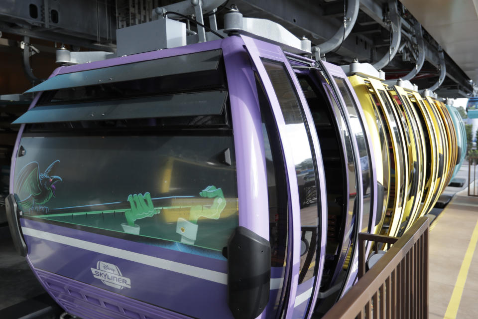 Gondolas line up in a station before boarding passengers to various locations at Walt Disney World on the Disney Skyliner aerial tram, Friday, Sept. 27, 2019, in Lake Buena Vista, Fla. The Disney Skyliner gondolas opening to visitors on Sunday are the latest addition to one of the largest private transportation systems in the U.S.(AP Photo/John Raoux)