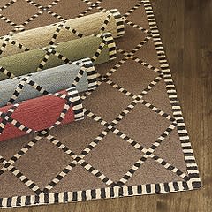 All the softness and texture of wool, except that this hand-hooked rug is done in rugged poly-acrylic.