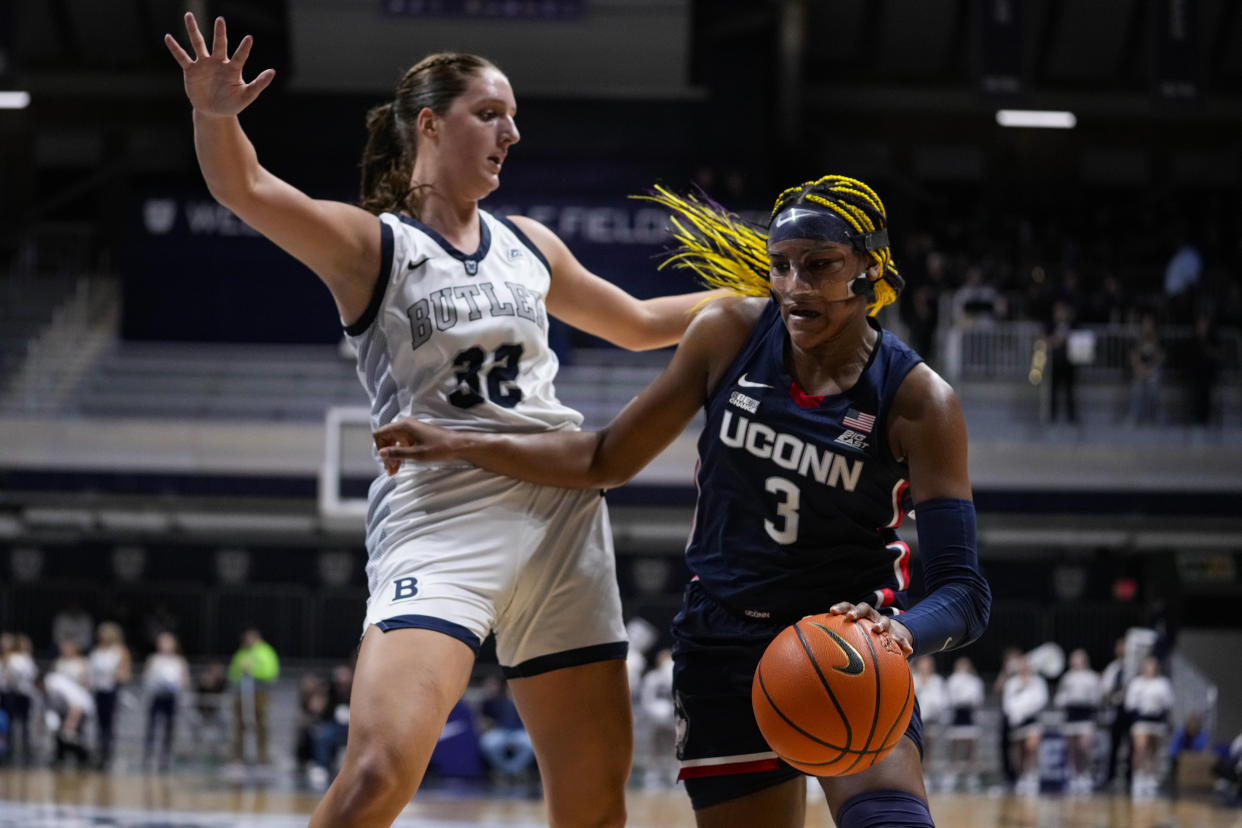 UConn forward Aaliyah Edwards drives on Butler forward Sydney Jaynes during the first half of a women's college basketball game in Indianapolis on Jan. 3, 2023. (AP/Michael Conroy)