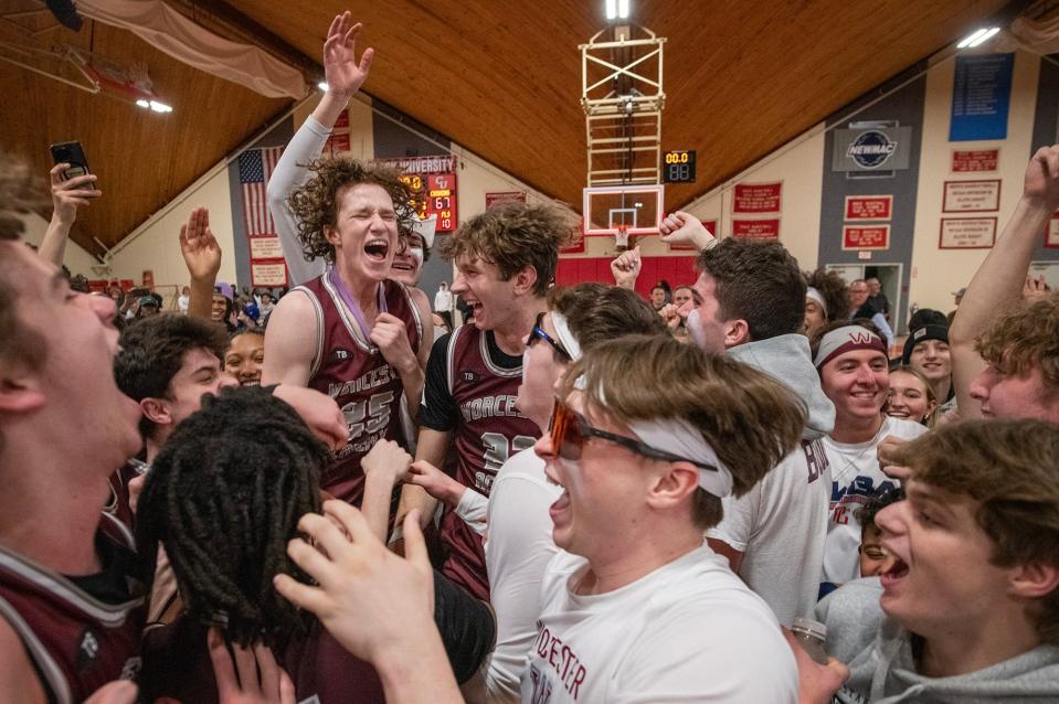 Worcester Academy's Parker Jones and T.J. Power celebrate with Hilltopper fans after they beat Cushing Academy for the NEPSAC Class AA title.