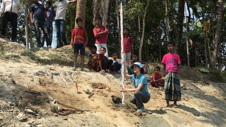 Rachel Bain, co-author of the report and a researcher at Vanderbilt University in Nashville conducting the study, surveys the elevation and orientation of sand dikes in the Ganges floodplain in Bangladesh.  - Liz Chamberlain