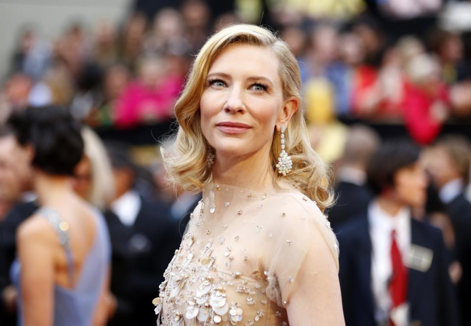 Cate Blanchett, best actress nominee for her role in "Blue Jasmine," wears a nude Armani gown with metallic embellishments as she arries at the 86th Academy Awards in Hollywood