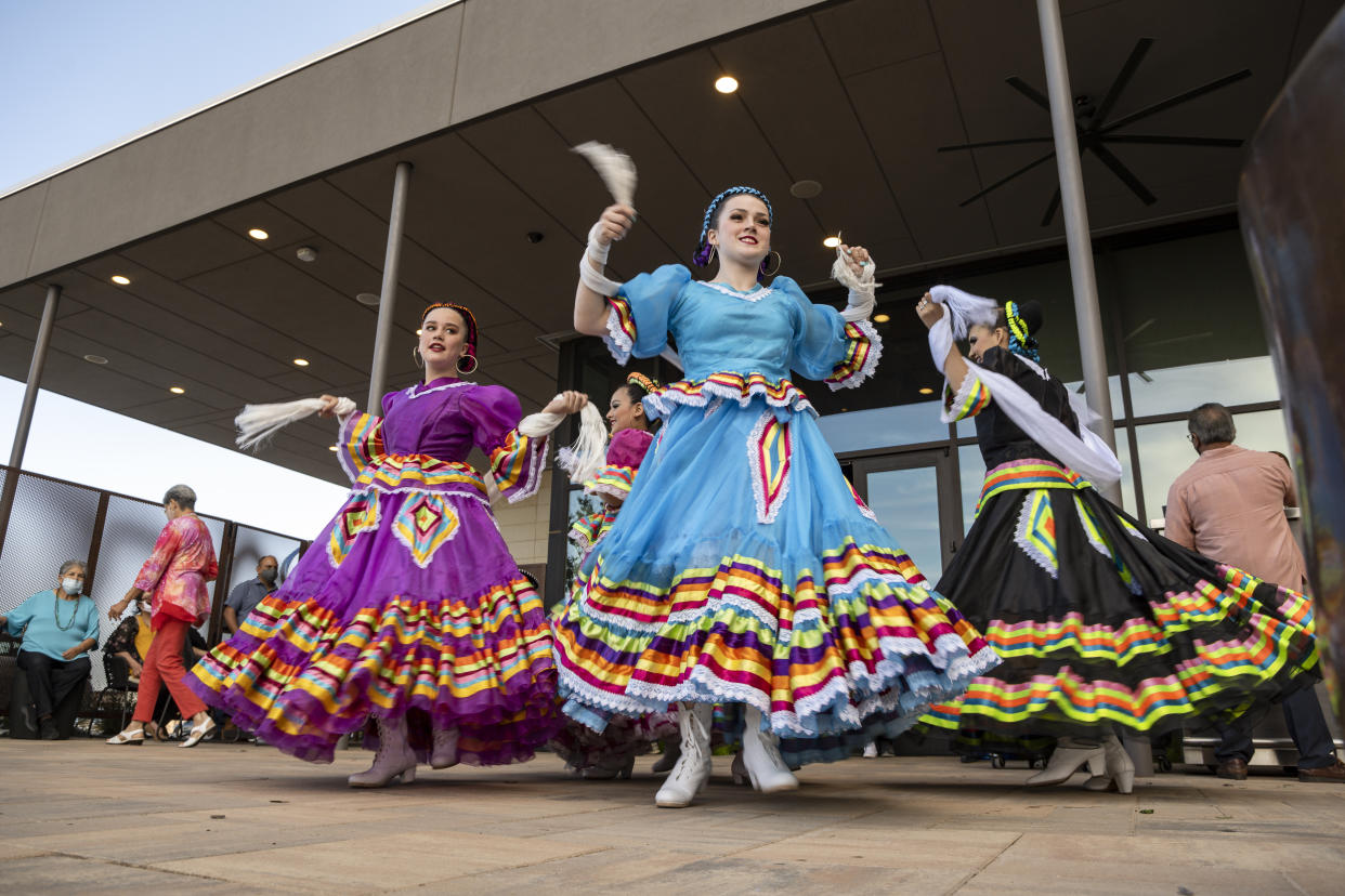 FILE -Young Folklorico dancers from the group Viva Mexico begin their dance routine at a Cinco de Mayo celebration hosted by the Odessa Hispanic Chamber of Commerce at the Odessa Marriott Hotel and Convention Center, Wednesday, May 5, 2021, in Odessa, Texas. American bars and restaurants gear up every year for Cinco de Mayo, offering special deals on Mexican food and alcoholic drinks for the May 5 holiday that is barely celebrated south of the border. (Eli Hartman/Odessa American via AP, File)