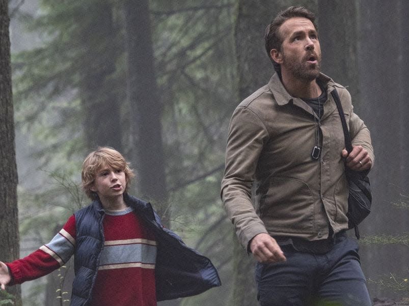 Walker Scobell in a vest, Ryan Reynolds in a cream jacket