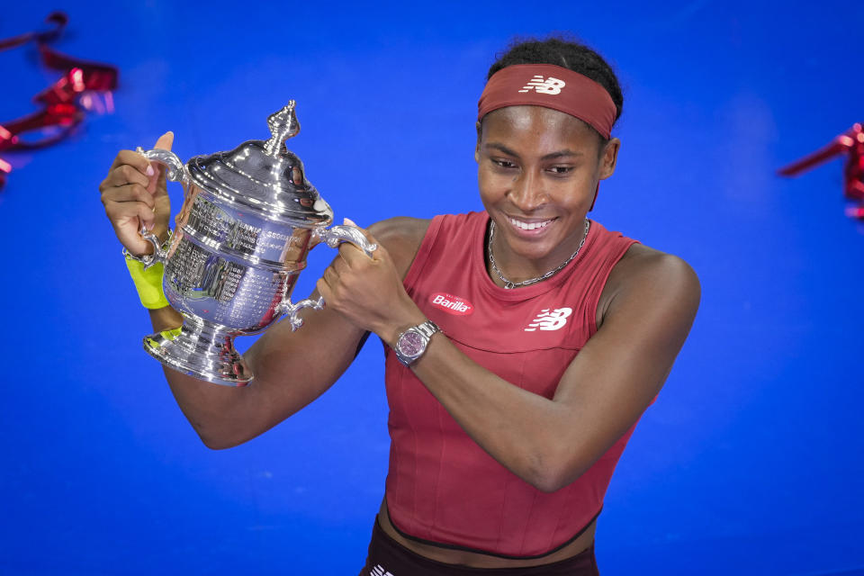 Coco Gauff, of the United States, poses for photographs after defeating Aryna Sabalenka, of Belarus, at the women's singles final of the U.S. Open tennis championships, Saturday, Sept. 9, 2023, in New York. (AP Photo/John Minchillo)