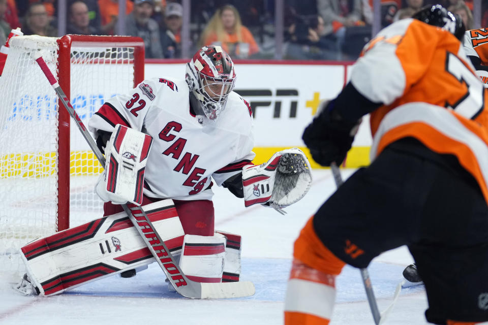 Carolina Hurricanes' Antti Raanta, left, cannot stop a goal by Philadelphia Flyers' Owen Tippett, right, during the second period of an NHL hockey game, Saturday, Oct. 29, 2022, in Philadelphia. (AP Photo/Matt Slocum)