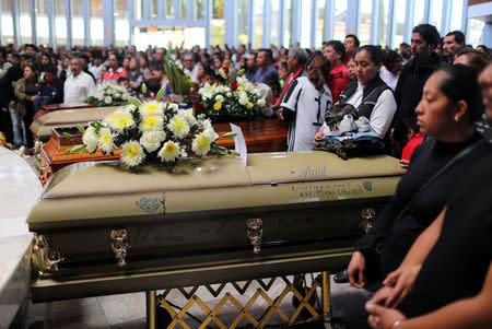 Relatives of people who died in an explosion of a fuel pipeline ruptured by oil thieves attend their funeral mass at a church in the municipality of Tlahuelilpan, state of Hidalgo, Mexico January 21, 2019. REUTERS/Mohammed Salem