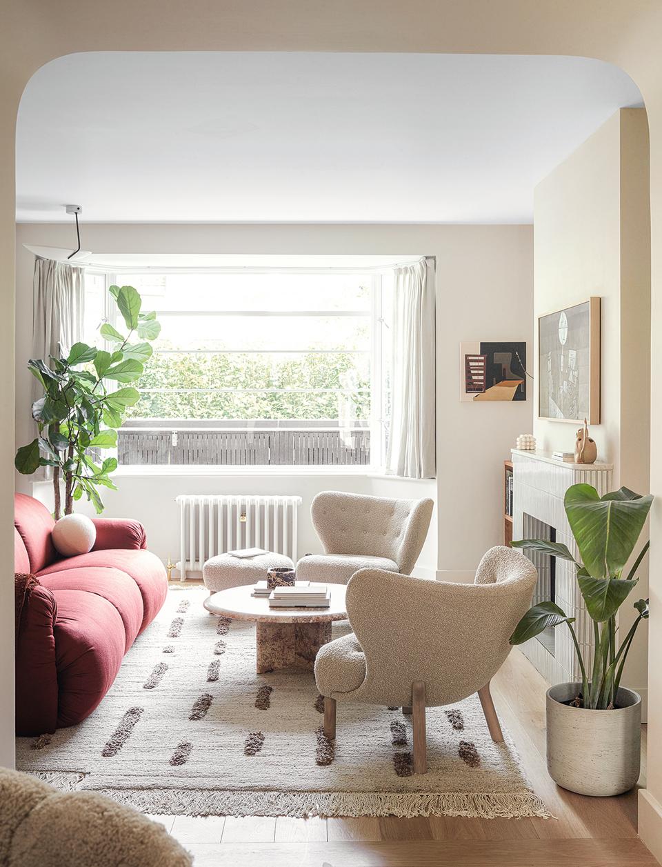 white living room with modern armchairs and red sofa